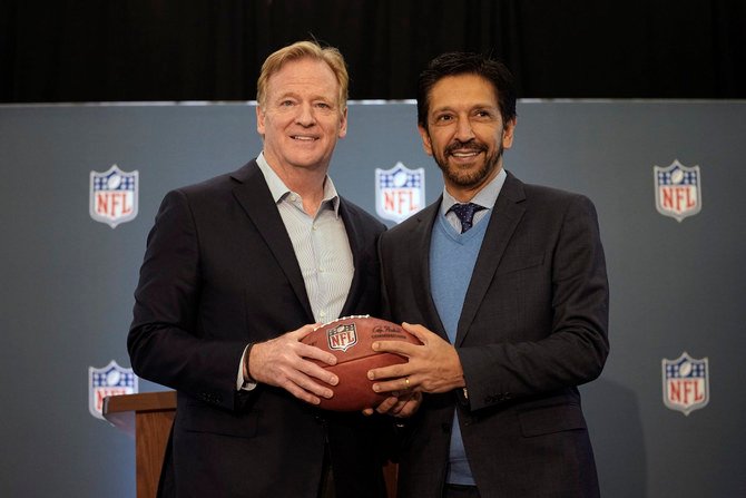 NFL Commissioner Roger Goodell, left, poses with a football with the mayor of Sao Paulo, Brazil, Ricardo Nunes, during a news conference at the NFL owners meeting in Irving, Texas, on Dec. 13, 2023. The NFL announced that a regular season game will be played in Sao Paulo. (AP)